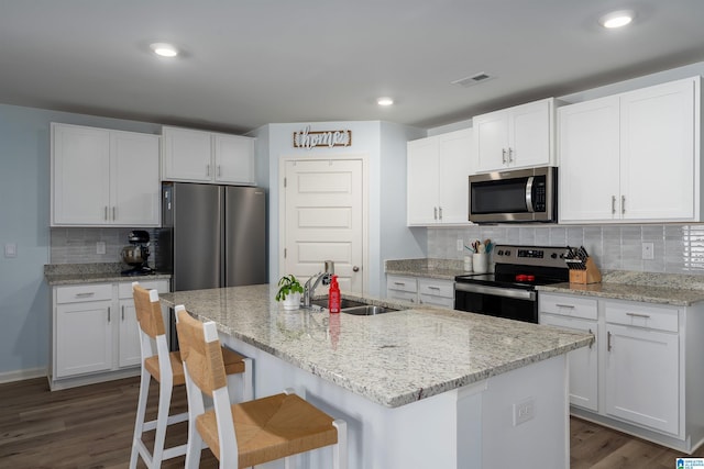 kitchen featuring stainless steel appliances, white cabinetry, and sink