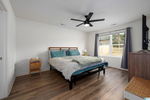 bedroom with ceiling fan and dark hardwood / wood-style floors