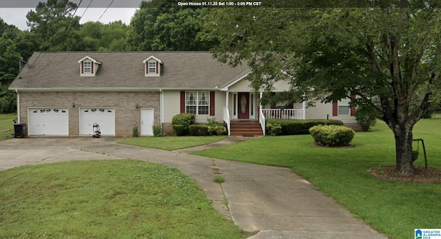 view of front facade with a garage, covered porch, and a front yard