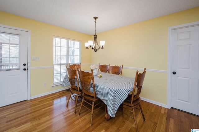 dining space with a chandelier and hardwood / wood-style flooring