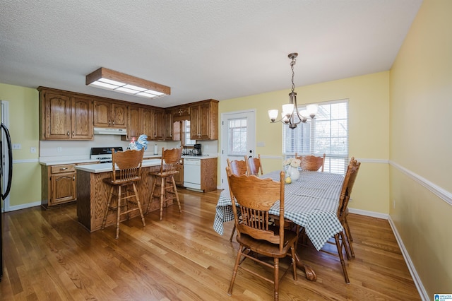 dining room featuring dark hardwood / wood-style flooring and an inviting chandelier