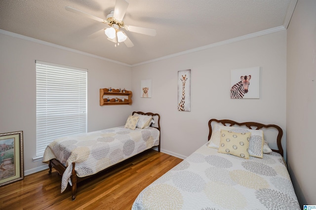 bedroom with ceiling fan, ornamental molding, a textured ceiling, and hardwood / wood-style flooring