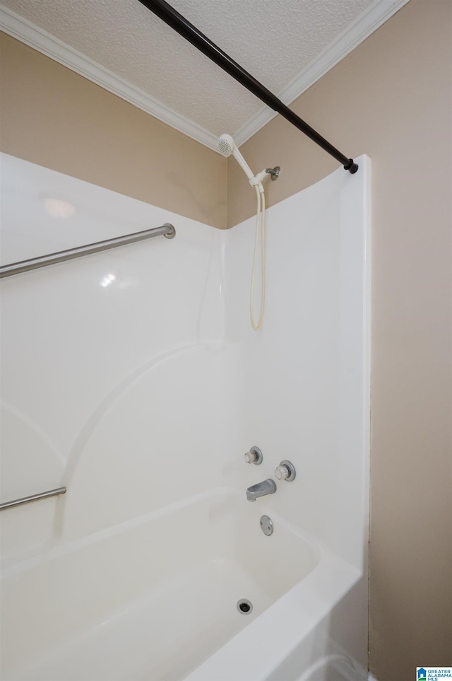 bathroom featuring a textured ceiling, shower / bath combination, and ornamental molding