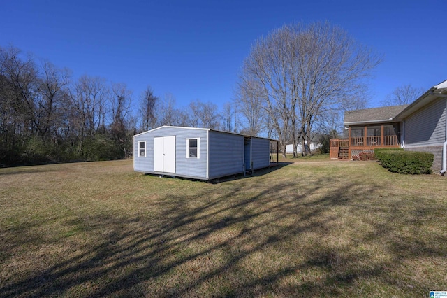 view of yard with a shed and a wooden deck