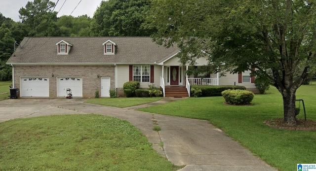 view of front of house featuring a porch, a garage, and a front lawn