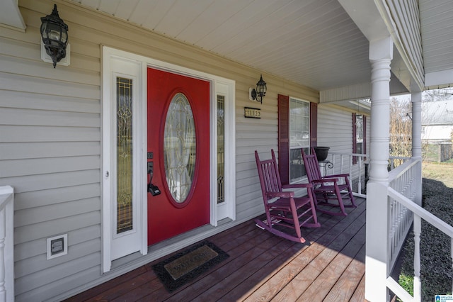 view of exterior entry featuring covered porch