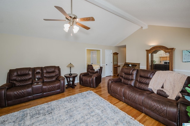 living room with lofted ceiling with beams, ceiling fan, and light hardwood / wood-style floors