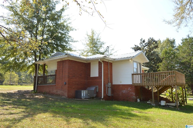 view of property exterior featuring a yard, central AC, and a deck