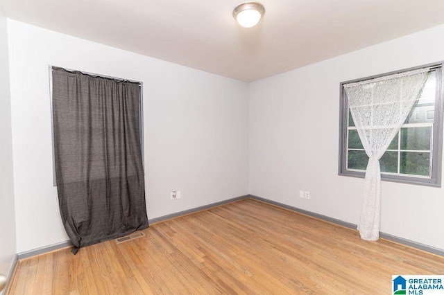 empty room with wood-type flooring