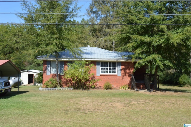 ranch-style home with a carport and a front lawn