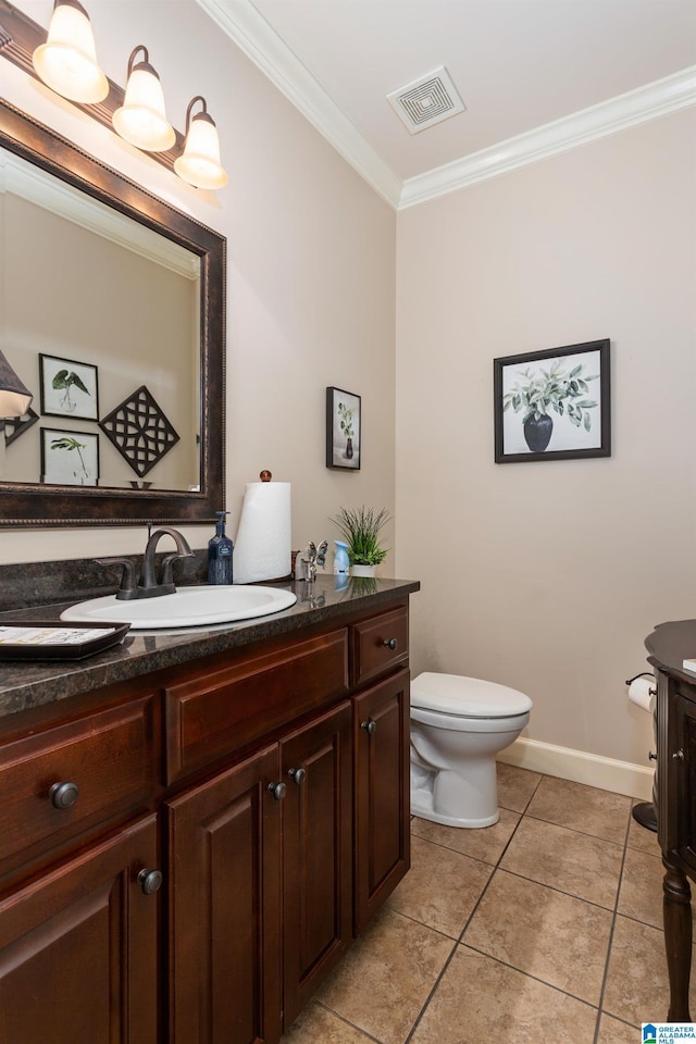 bathroom featuring tile patterned flooring, vanity, toilet, and ornamental molding