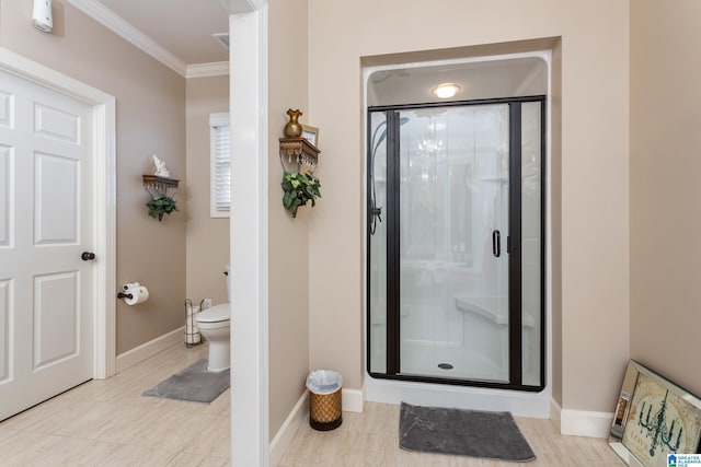 bathroom featuring toilet, a shower with door, and crown molding