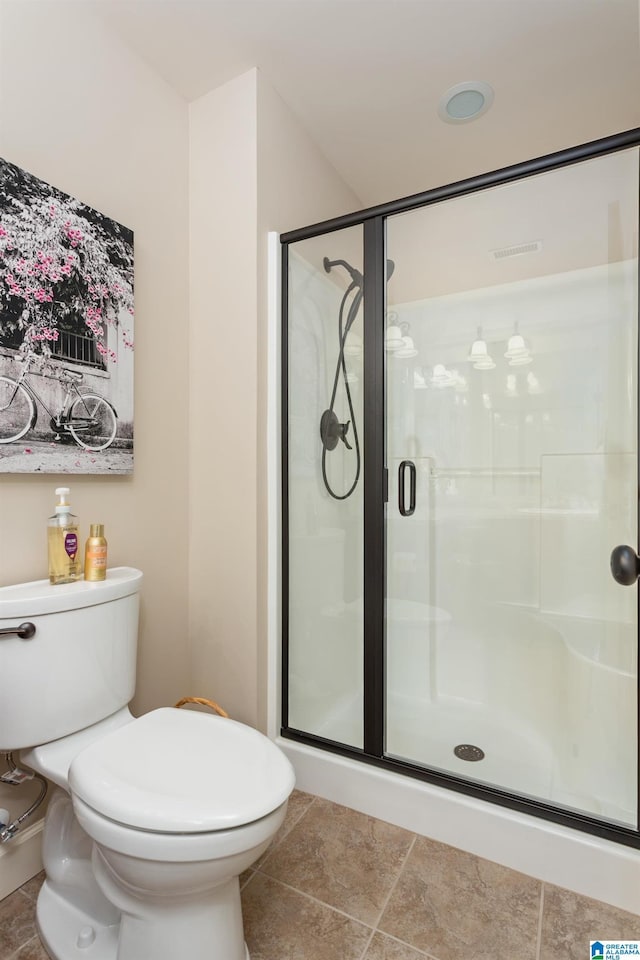 bathroom with an enclosed shower and toilet