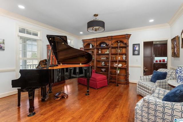 sitting room featuring ornamental molding and hardwood / wood-style flooring