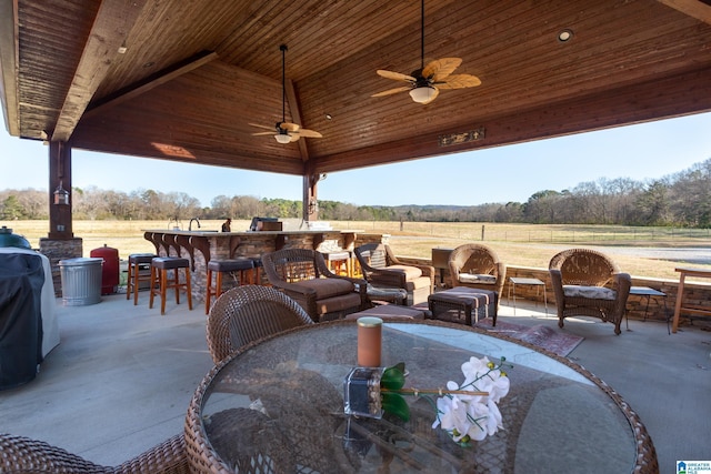 view of patio / terrace featuring a gazebo, ceiling fan, an outdoor bar, and a rural view