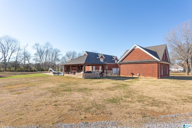 rear view of house featuring a lawn