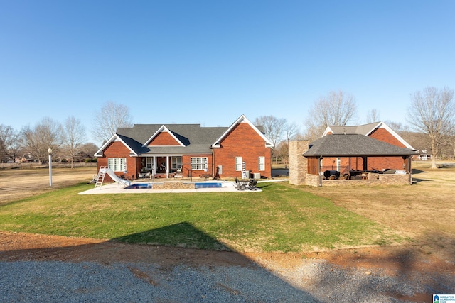 view of front of property with a gazebo, a patio area, and a front lawn