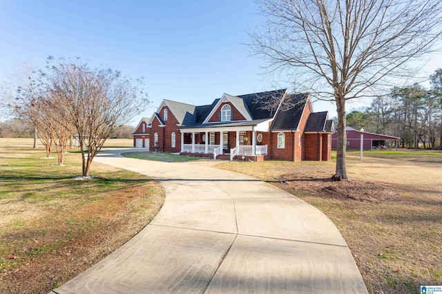 cape cod-style house featuring a porch, a garage, and a front lawn