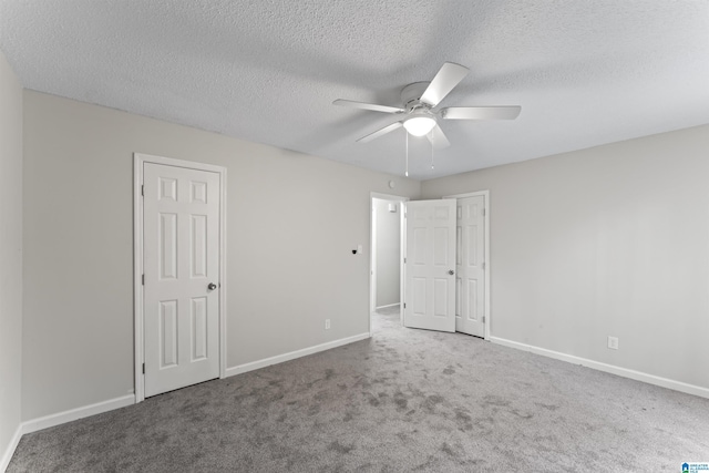 spare room featuring carpet, a textured ceiling, and ceiling fan