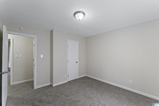 unfurnished bedroom featuring carpet flooring, a textured ceiling, and a closet