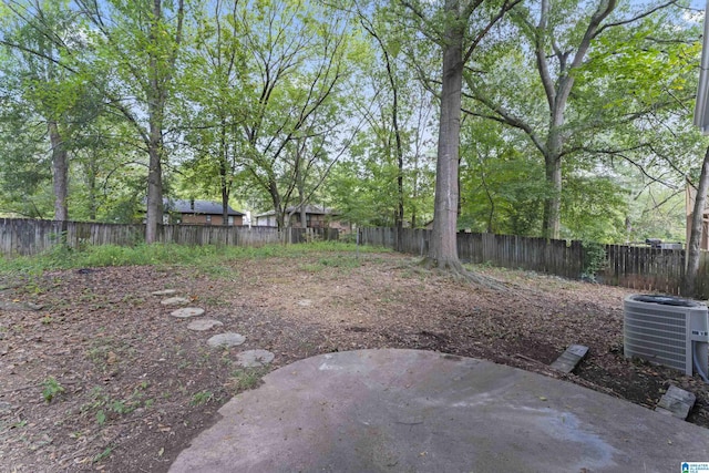 view of yard with cooling unit and a patio