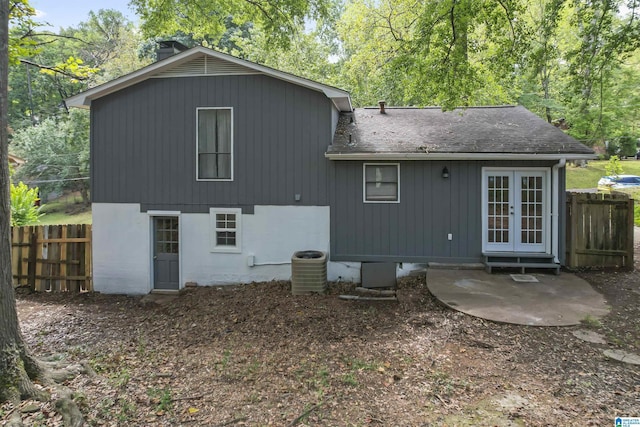 rear view of house featuring central AC and french doors