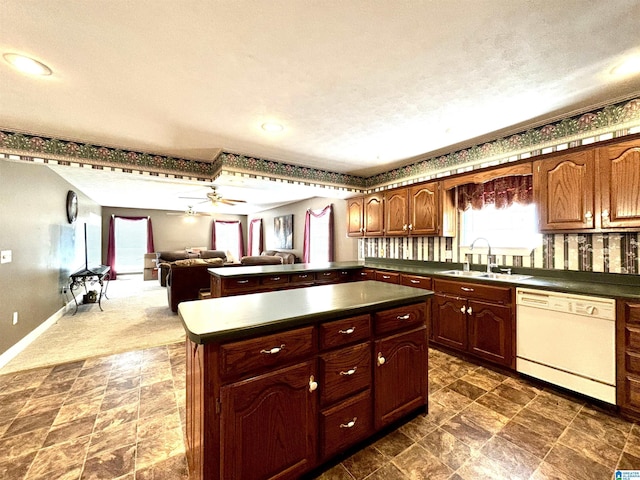 kitchen with a textured ceiling, white dishwasher, ceiling fan, sink, and a center island