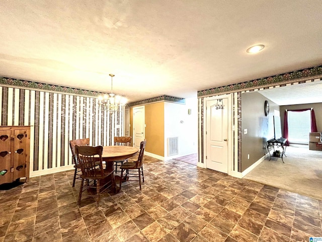 dining area with a chandelier and a textured ceiling