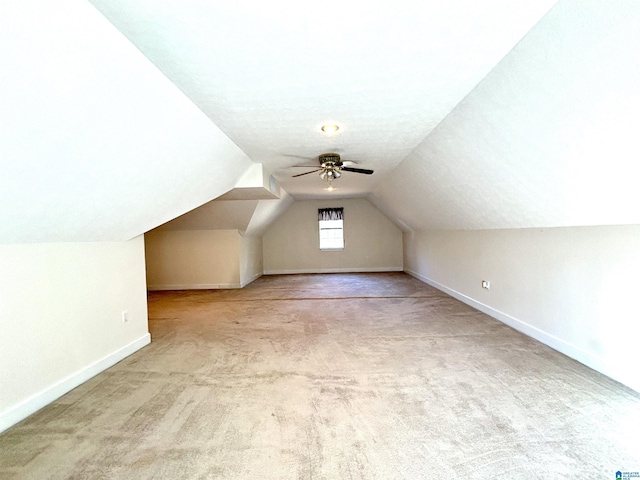 bonus room with ceiling fan, light colored carpet, lofted ceiling, and a textured ceiling