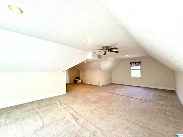 bonus room with carpet, ceiling fan, a textured ceiling, and vaulted ceiling