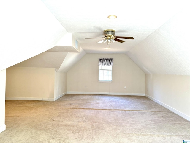 bonus room featuring light carpet, a textured ceiling, ceiling fan, and lofted ceiling