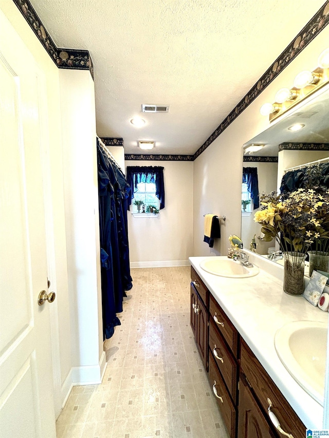 bathroom featuring vanity and a textured ceiling