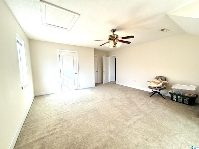 interior space with ceiling fan, light carpet, and vaulted ceiling