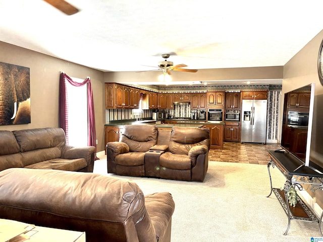 living room featuring ceiling fan and light carpet