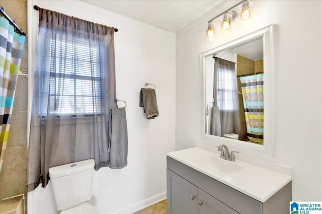 bathroom with tile patterned flooring, vanity, ornamental molding, and toilet