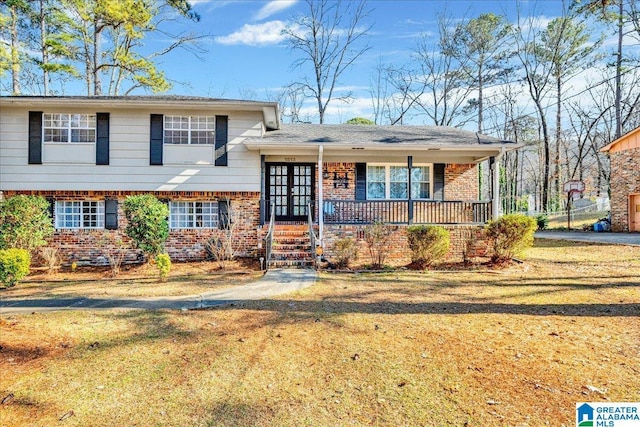 tri-level home featuring a front yard and covered porch