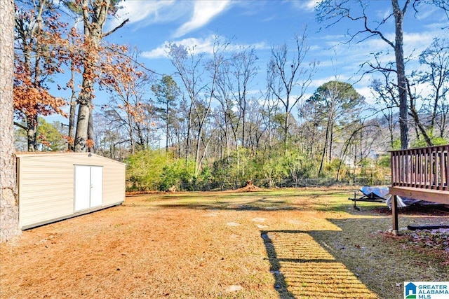 view of yard with a storage shed and a wooden deck