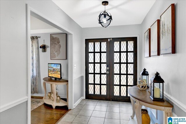 doorway with tile patterned floors and french doors