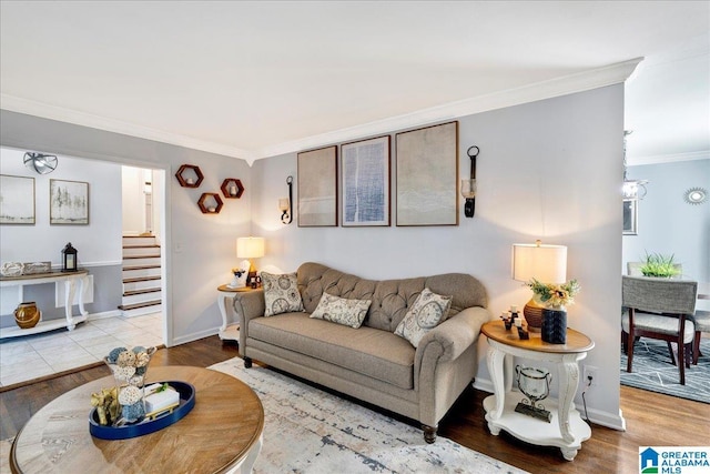 living room featuring crown molding and light hardwood / wood-style flooring