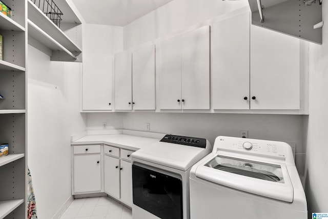 laundry room featuring cabinets and separate washer and dryer