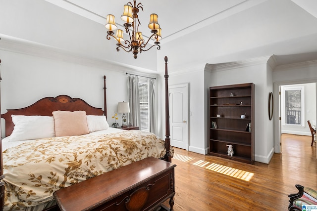 bedroom featuring a notable chandelier, wood-type flooring, and ornamental molding