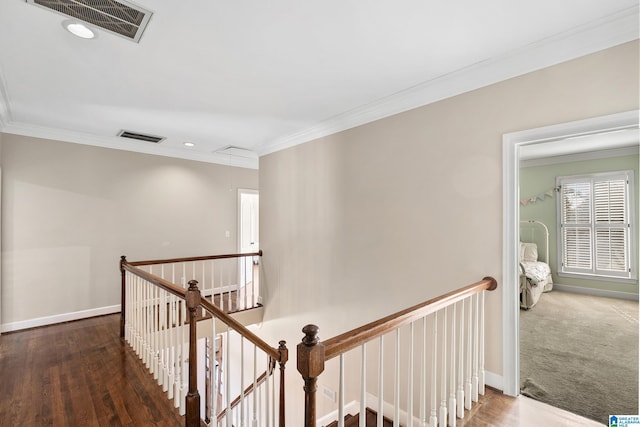 hall with dark hardwood / wood-style flooring and crown molding