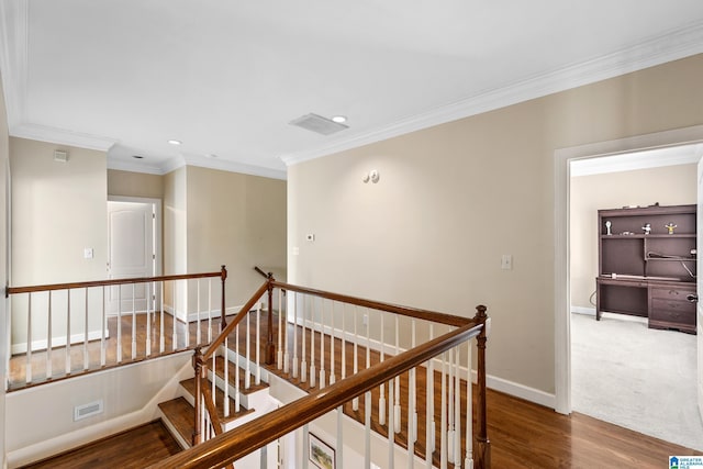 hallway with wood-type flooring and crown molding