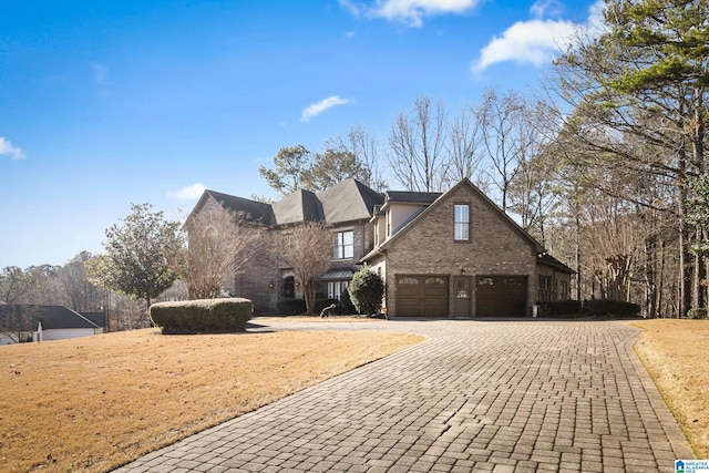 view of front of property with a front lawn and a garage