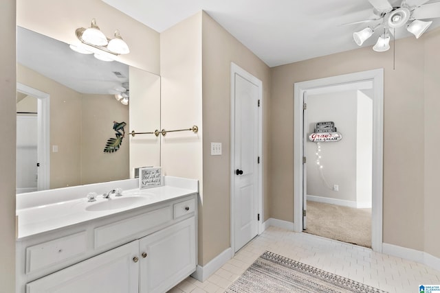 bathroom with tile patterned flooring, vanity, and ceiling fan