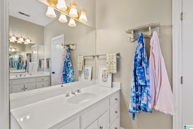 bathroom with vanity and an inviting chandelier