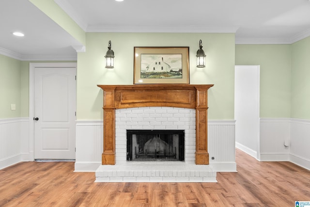 unfurnished living room with ornamental molding, a fireplace, and light hardwood / wood-style flooring