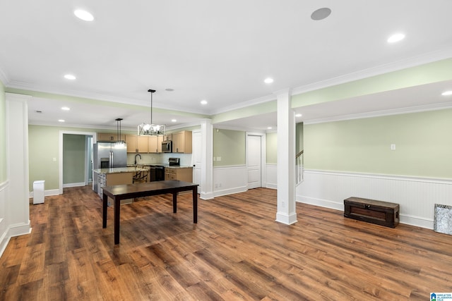 recreation room with dark hardwood / wood-style floors, sink, crown molding, and a chandelier