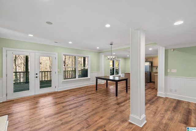 interior space featuring french doors, an inviting chandelier, ornamental molding, and wood-type flooring