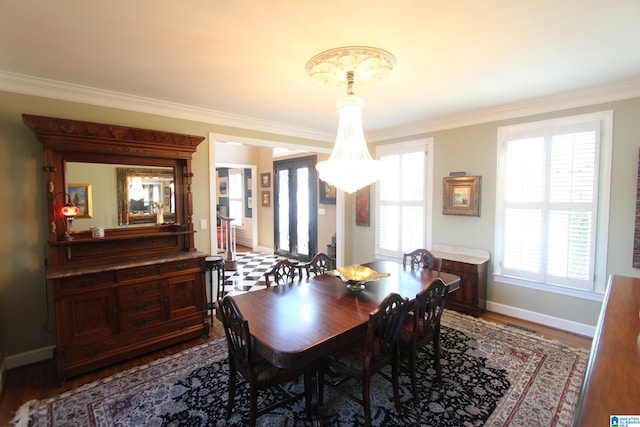 dining space with hardwood / wood-style flooring, crown molding, a wealth of natural light, and french doors